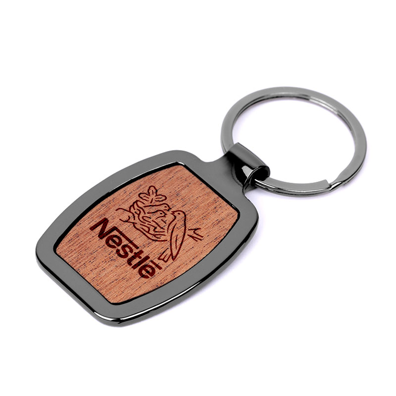 Revere Oval Wood Key Chain - Meet the Greenwich Wood Key Chain, where urban cool meets natural charm. This sleek accessory isn't just about keeping your keys together, it's a statement piece that elevates your everyday carry. Metal is a zinc alloy with gunmetal plating and an oval-like design. Key chain front features a rosewood in a clear finish. 35mm split ring also with gunmetal plating. A gift box is included for a stylish presentation.